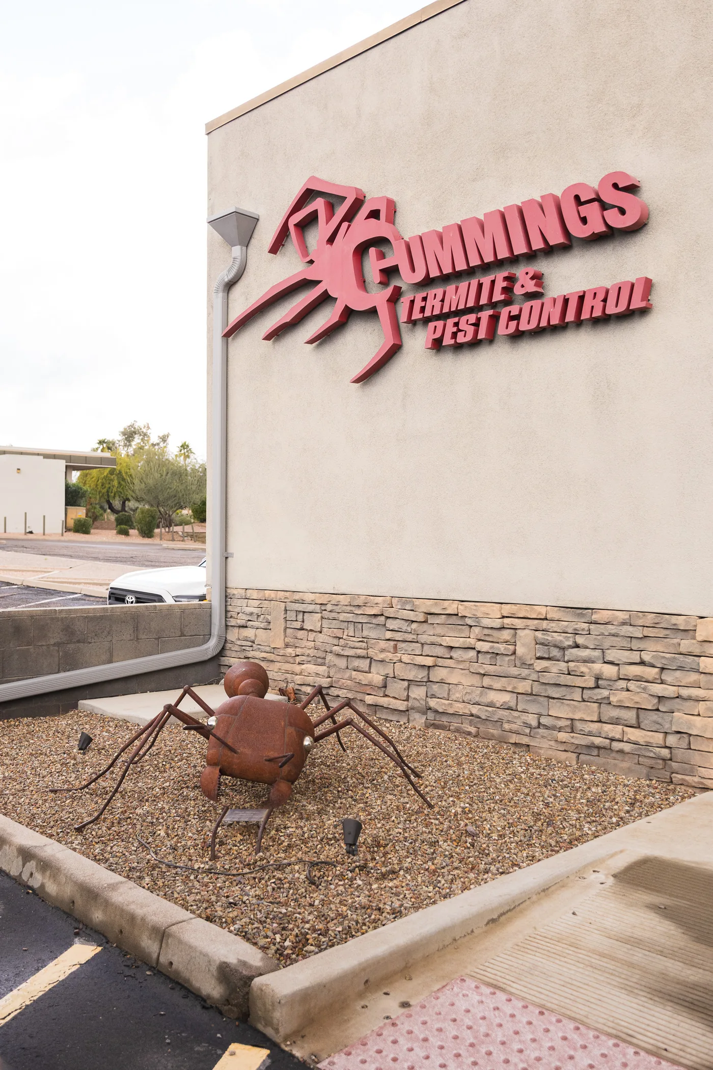 Cummings Termite and Pest office sign with ant sculpture outside